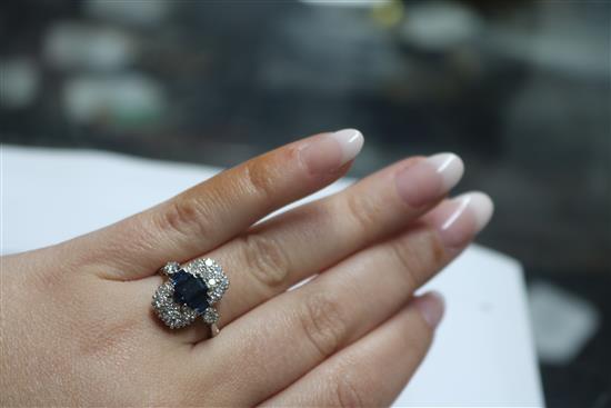 An Art Deco style white metal, sapphire and diamond ring, size M.